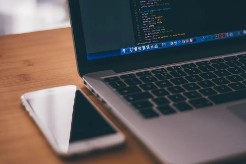 Mobile app QA testers checking code, devices, and app quality before release