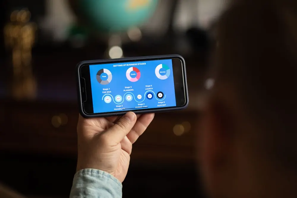 Mobile app testing company reviewing app quality data and release readiness on a smartphone